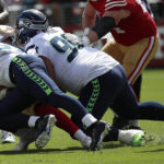 
              Seattle Seahawks linebacker Cody Barton, left, and defensive tackle Bryan Mone tackle San Francisco 49ers quarterback Trey Lance during the first half of an NFL football game in Santa Clara, Calif., Sunday, Sept. 18, 2022. Lance left the game after this play. (AP Photo/Josie Lepe)
            
