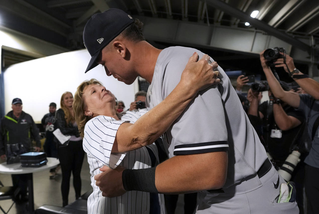 New York Yankees' Aaron Judge hugs his mother, Patty Judge, after the team's baseball game against ...
