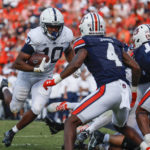 
              Penn State running back Nicholas Singleton (10) carries the ball in for a touchdown against Auburn during the second half of an NCAA college football game, Saturday, Sept. 17, 2022, in Auburn, Ala. (AP Photo/Butch Dill)
            