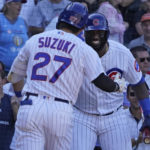 
              Chicago Cubs' Seiya Suzuki (27) is greeted by Franmil Reyes, right, after hitting a home run against the Cincinnati Reds during the eighth inning of a baseball game, Thursday, Sept. 8, 2022, in Chicago. (AP Photo/David Banks)
            