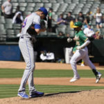 
              New York Mets starting pitcher Jacob deGrom, left, stands on the mound as Oakland Athletics' Seth Brown, right, rounds the bases after hitting a solo home run during the third inning of a baseball game in Oakland, Calif., Saturday, Sept. 24, 2022. (AP Photo/Tony Avelar)
            