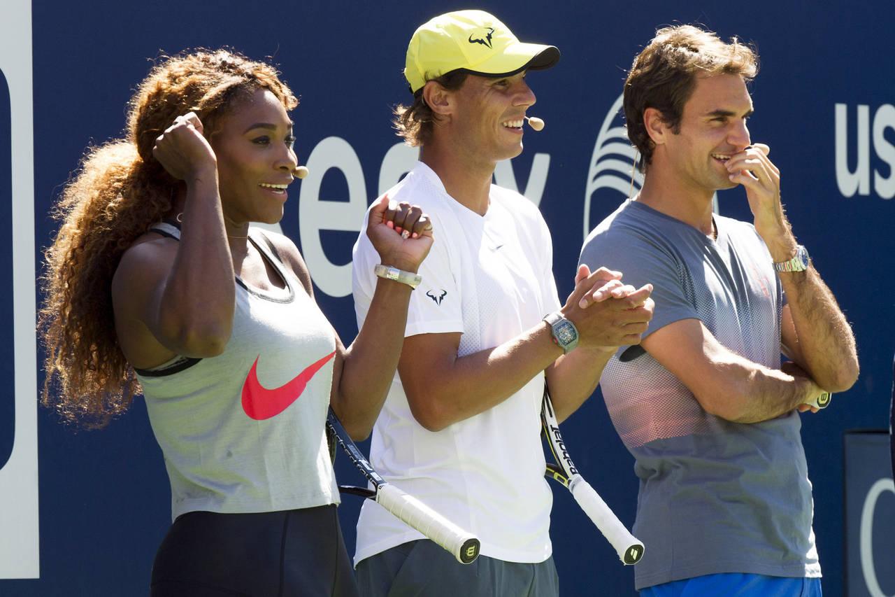 FILE - Serena Williams, Rafael Nadal and Roger Federer, right, cheer on the competition during Arth...