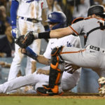
              San Francisco Giants catcher Austin Wynns tags Los Angeles Dodgers' Austin Barnes out at home during the fifth inning of a baseball game Monday, Sept. 5, 2022, in Los Angeles. (AP Photo/John McCoy)
            