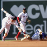 
              Boston Red Sox second baseman Trevor Story, left, swipe-tags Texas Rangers' Leody Traveras, right, for an out on a steal-attempt during the sixth inning of a baseball game at Fenway Park, Sunday, Sept. 4, 2022, in Boston.(AP Photo/Paul Connors)
            