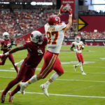 
              Kansas City Chiefs tight end Travis Kelce (87) catches a pass for a touchdown against Arizona Cardinals linebacker Isaiah Simmons (9) during the first half of an NFL football game, Sunday, Sept. 11, 2022, in Glendale, Ariz. (AP Photo/Ross D. Franklin)
            