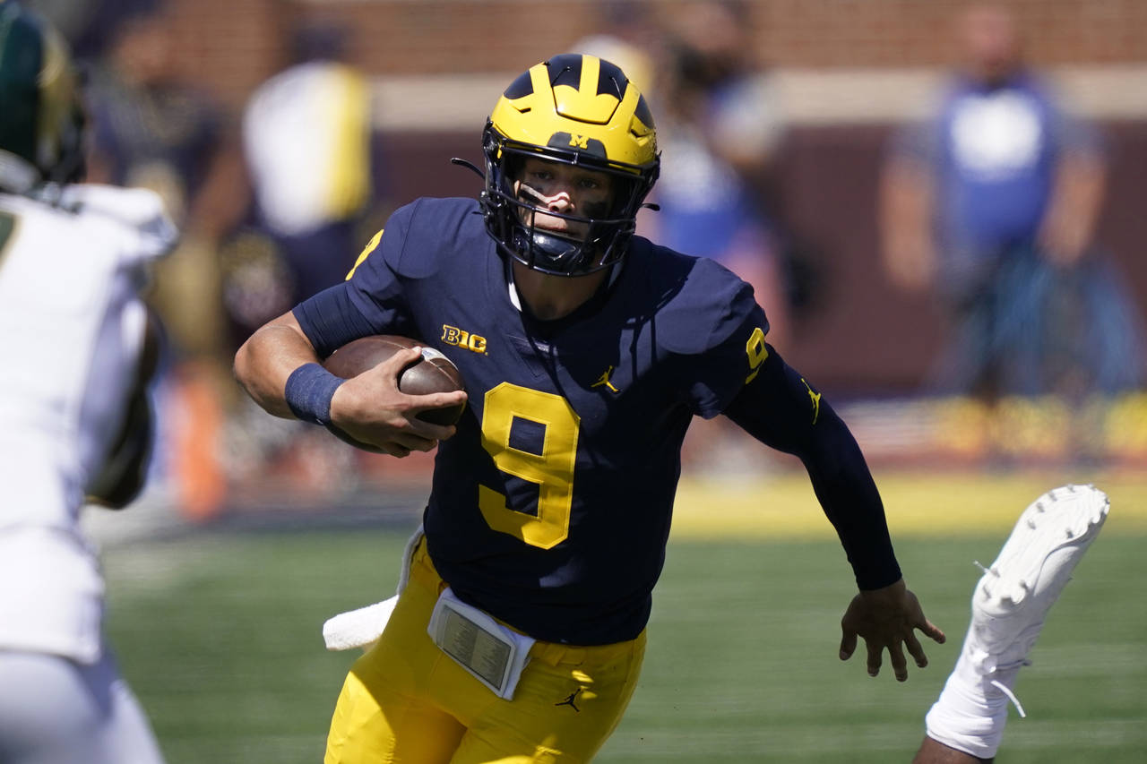 FILE - Michigan quarterback J.J. McCarthy rushes during the second half of an NCAA college football...