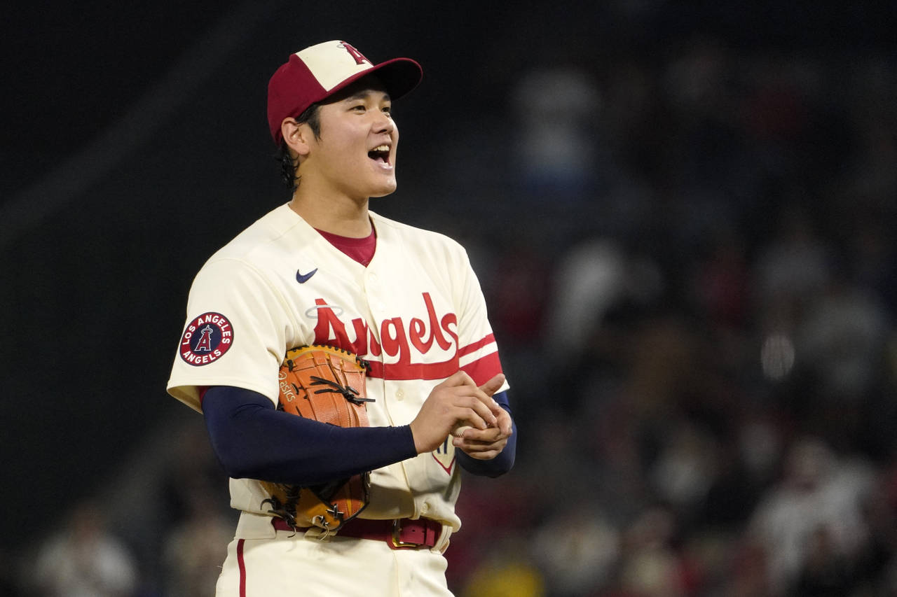 Los Angeles Angels starting pitcher Shohei Ohtani looks toward the plate after giving up a hit to O...