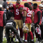 
              San Francisco 49ers quarterback Trey Lance (5) is helped onto a cart during the first half of an NFL football game against the Seattle Seahawks in Santa Clara, Calif., Sunday, Sept. 18, 2022. (AP Photo/Tony Avelar)
            