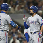 
              Texas Rangers' Marcus Semien, right, celebrates with Nathaniel Lowe after hitting two-run home run off Seattle Mariners starting pitcher Marco Gonzales during the third inning a of a baseball game Thursday, Sept. 29, 2022, in Seattle. (AP Photo/Stephen Brashear)
            