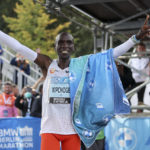 
              Kenya's Eliud Kipchoge celebrates after winning the Berlin Marathon in Berlin, Germany, Sunday, Sept. 25, 2022. Olympic champion Eliud Kipchoge has bettered his own world record in the Berlin Marathon. Kipchoge clocked 2:01:09 on Sunday to shave 30 seconds off his previous best-mark of 2:01:39 from the same course in 2018. (AP Photo/Christoph Soeder)
            