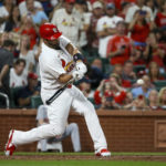 
              St. Louis Cardinals' Albert Pujols hits a two-run home run during the sixth inning of a baseball game against the Cincinnati Reds, Friday, Sept. 16, 2022, in St. Louis. (AP Photo/Scott Kane)
            