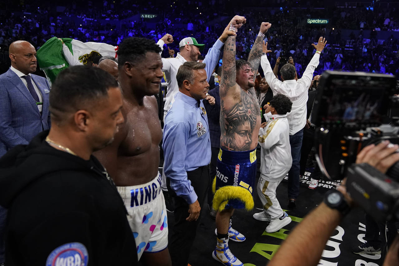 Andy Ruiz, Jr., center, celebrates after winning a WBC world heavyweight title eliminator boxing ma...