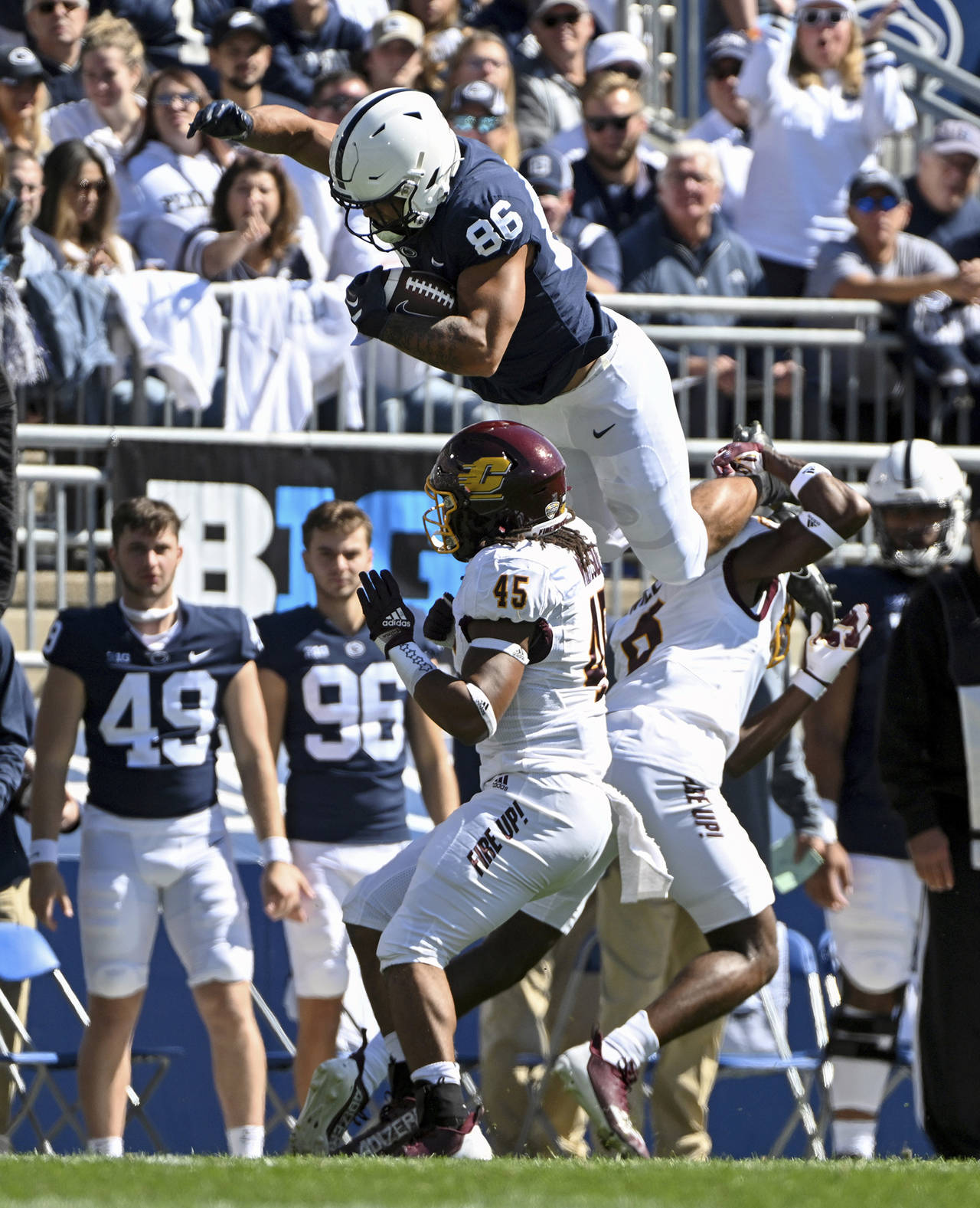 Penn State tight end Brenton Strange (86) hurdles Central Michigan defenders Lavario Wiley (6) and ...