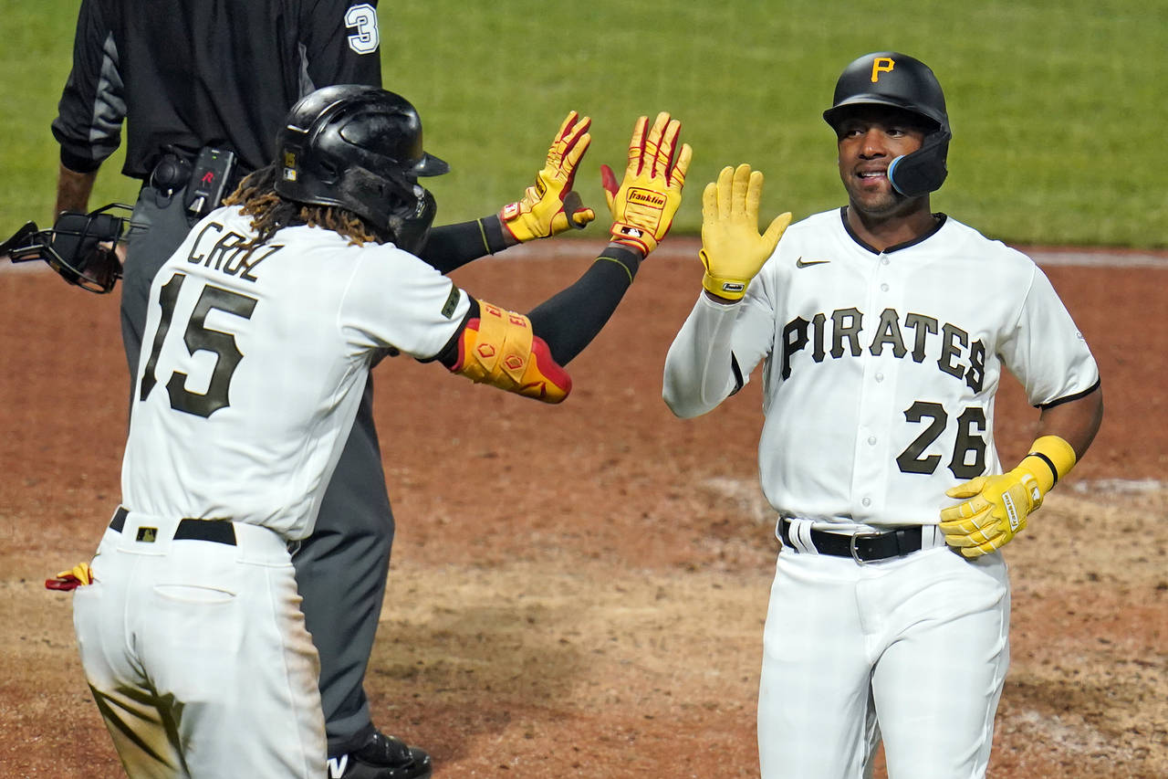 Pittsburgh Pirates' Miguel Andujar (26) and Oneil Cruz (15) celebrate after scoring on a double by ...