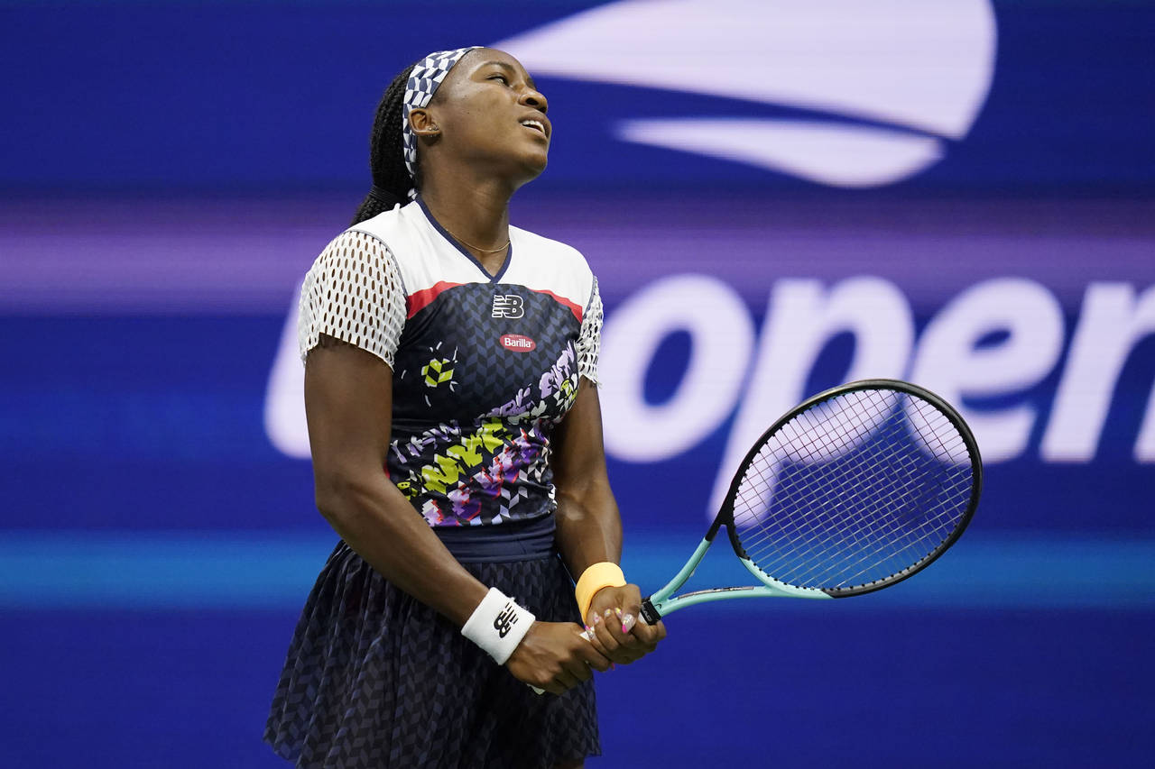 Coco Gauff, of the United States, reacts as she plays Caroline Garcia, of France, during the quarte...