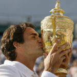 
              FILE - Switzerland's Roger Federer kisses the trophy after defeating Rafael Nadal to win his fifth consecutive Men's Singles Championship on the Centre Court at Wimbledon, Sunday July 8, 2007. Federer announced Thursday, Sept.15, 2022 he is retiring from tennis. (AP Photo/Anja Niedringhaus, File)
            