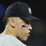 
              New York Yankees' Aaron Judge looks back to the dugout as he walks out to his position during the third inning of the team's baseball game against the Toronto Blue Jays on Tuesday, Sept. 27, 2022, in Toronto. (Nathan Denette/The Canadian Press via AP)
            