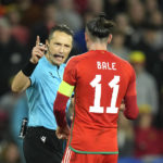 
              Wales' Gareth Bale argues with referee Andris Treimanis during the UEFA Nations League soccer match between Wales and Poland at the Cardiff City Stadium in Cardiff, Wales, Sunday, Sept. 25, 2022. (AP Photo/Frank Augstein)
            
