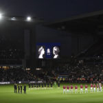 
              Players stand on the center of the pitch during a moment of silence tribute to Queen Elizabeth II before the English Premier League soccer match between Aston Villa and Southampton at Villa Park in Birmingham, England, Friday, Sept. 16, 2022. (AP Photo/Rui Vieira)
            