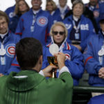 
              FILE - Rev. Burke Masters conducts an outdoor Mass in the Wrigley Field stands prior to Game 5 of the Major League Baseball World Series between the Cleveland Indians and the Chicago Cubs Sunday, Oct. 30, 2016, in Chicago. A poll by The Associated Press and the NORC Center for Public Affairs Research conducted Sept. 9-12, 2022, finds that about 3 in 10 Americans say they feel God plays a role in determining which team goes home the victor. (AP Photo/Charlie Riedel, File)
            