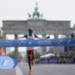 
              Kenya's Eliud Kipchoge crosses the line to win the Berlin Marathon in Berlin, Germany, Sunday, Sept. 25, 2022. Olympic champion Eliud Kipchoge has bettered his own world record in the Berlin Marathon. Kipchoge clocked 2:01:09 on Sunday to shave 30 seconds off his previous best-mark of 2:01:39 from the same course in 2018. (AP Photo/Christoph Soeder)
            