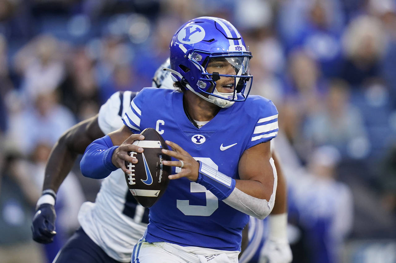BYU quarterback Jaren Hall looks for a receiver during the first half of the team's NCAA college fo...