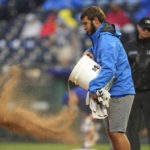 
              A member of the Kansas City Royals grounds crew adds dirt to the mound during the sixth inning of a baseball game against the Detroit Tigers Saturday, Sept. 10, 2022, in Kansas City, Mo. (AP Photo/Jay Biggerstaff)
            