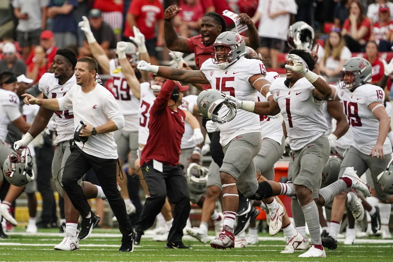 Washington State players celebrate after an NCAA college football game against WisconsinSaturday, S...