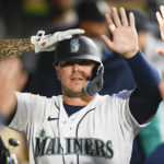 
              Seattle Mariners' Ty France celebrates with his teammates in the dugout after scoring a run off of Mitch Haniger's sacrifice fly during the first inning of a baseball game against the Texas Rangers, Wednesday, Sept. 28, 2022, in Seattle. (AP Photo/Caean Couto)
            