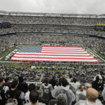 
              Fans watch pre-game ceremonies before an NFL football game between the New York Jets and the Baltimore Ravens Sunday, Sept. 11, 2022, in East Rutherford, N.J. (AP Photo/John Munson)
            