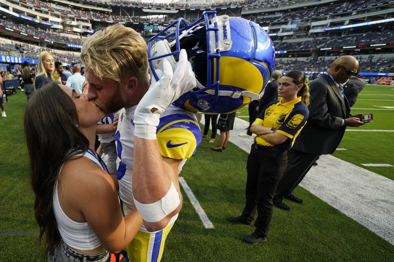 Los Angeles Rams wide receiver Cooper Kupp kisses his wife Anna before an NFL football game against...