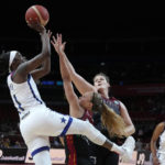
              United States' Kahleah Copper, left, shoots over Belgium's Julie Allemand, second left, and Kyara Linskens during their women's Basketball World Cup game in Sydney, Australia, Thursday, Sept. 22, 2022. (AP Photo/Mark Baker)
            