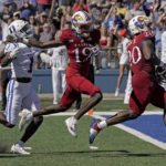 
              Kansas running back Daniel Hishaw Jr. (20) scores a touchdown during the first half of an NCAA college football game against Duke Saturday, Sept. 24, 2022, in Lawrence, Kan. (AP Photo/Charlie Riedel)
            