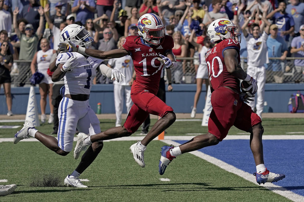 Kansas running back Daniel Hishaw Jr. (20) scores a touchdown during the first half of an NCAA coll...