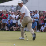 
              Tom Kim, of South Korea, watches his team-winning putt go in on the 18th green during their fourball match at the Presidents Cup golf tournament at the Quail Hollow Club, Saturday, Sept. 24, 2022, in Charlotte, N.C. (AP Photo/Chris Carlson)
            