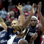 
              Guerschon Yabusele of France, right, applaudes after the the Eurobasket semi final basketball match between Poland and France in Berlin, Germany, Friday, Sept. 16, 2022. France defeated Poland by 95-54. (AP Photo/Michael Sohn)
            