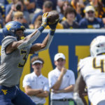
              West Virginia wide receiver Kaden Prather (3) makes a catch against Towson during the first half of an NCAA college football game in Morgantown, W.Va., Saturday, Sept. 17, 2022. (AP Photo/William Wotring)
            