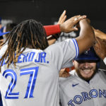 
              Toronto Blue Jays' Alejandro Kirk, right, is greeted in the dugout after scoring on a single by Matt Chapman against Baltimore Orioles starting pitcher Kyle Bradish during the second inning of a baseball game Tuesday, Sept. 6, 2022, in Baltimore. (AP Photo/Terrance Williams)
            