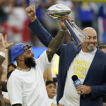 
              Former Los Angeles Rams wide receiver Odell Beckham Jr., center, lifts the 2021 championship trophy next to ex-player Andrew Whitworth, right, and team owner Stan Kroenke, left, before an NFL football game against the Buffalo Bills Thursday, Sept. 8, 2022, in Inglewood, Calif. (AP Photo/Ashley Landis)
            