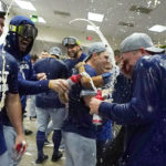 
              Los Angeles Dodgers celebrate in the locker room after a 4-0 win in a baseball game against the Arizona Diamondbacks in Phoenix, Tuesday, Sept. 13, 2022. The Dodgers clinched the National League West. (AP Photo/Ross D. Franklin)
            