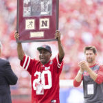 
              Johnny Rodgers holds up a commemorative plaque in honor of the 50th anniversary of his Heisman winning season with Nebraska during a break in play between Oklahoma and Nebraska during the first half of an NCAA college football game Saturday, Sept. 17, 2022, in Lincoln, Neb. (AP Photo/Rebecca S. Gratz)
            