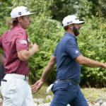 
              Cameron Smith, left, and Dustin Johnson head toward the fourth fairway during the final round of the LIV Golf Invitational-Chicago tournament Sunday, Sept. 18, 2022, in Sugar Hill, Ill. (AP Photo/Charles Rex Arbogast)
            