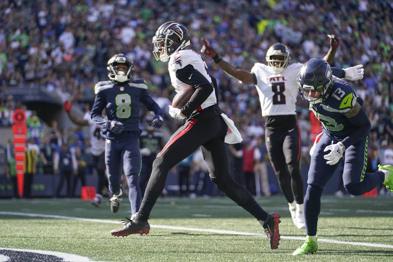 Atlanta Falcons wide receiver Drake London, center, scores a touchdown during the second half of an...