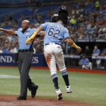 
              Tampa Bay Rays' Jonathan Aranda (62) reacts in front of home plate umpire umpire CB Bucknor after scoring against the Texas Rangers during the first inning of a baseball game Saturday, Sept. 17, 2022, in St. Petersburg, Fla. (AP Photo/Scott Audette)
            