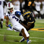 
              Louisiana Tech wide receiver Tre Harris (3) is stopped by Missouri defensive back Jaylon Carlies during the first half of an NCAA college football game Thursday, Sept. 1, in Columbia, Mo. (AP Photo/L.G. Patterson)
            