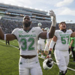 
              Marshall's Koby Cumberlander (32) and Eric Meeks (57) celebrate after the team defeated Notre Dame in an NCAA college football game Saturday, Sept. 10, 2022, in South Bend, Ind. Marshall won 26-21. (Sholten Singer/The Herald-Dispatch via AP)
            
