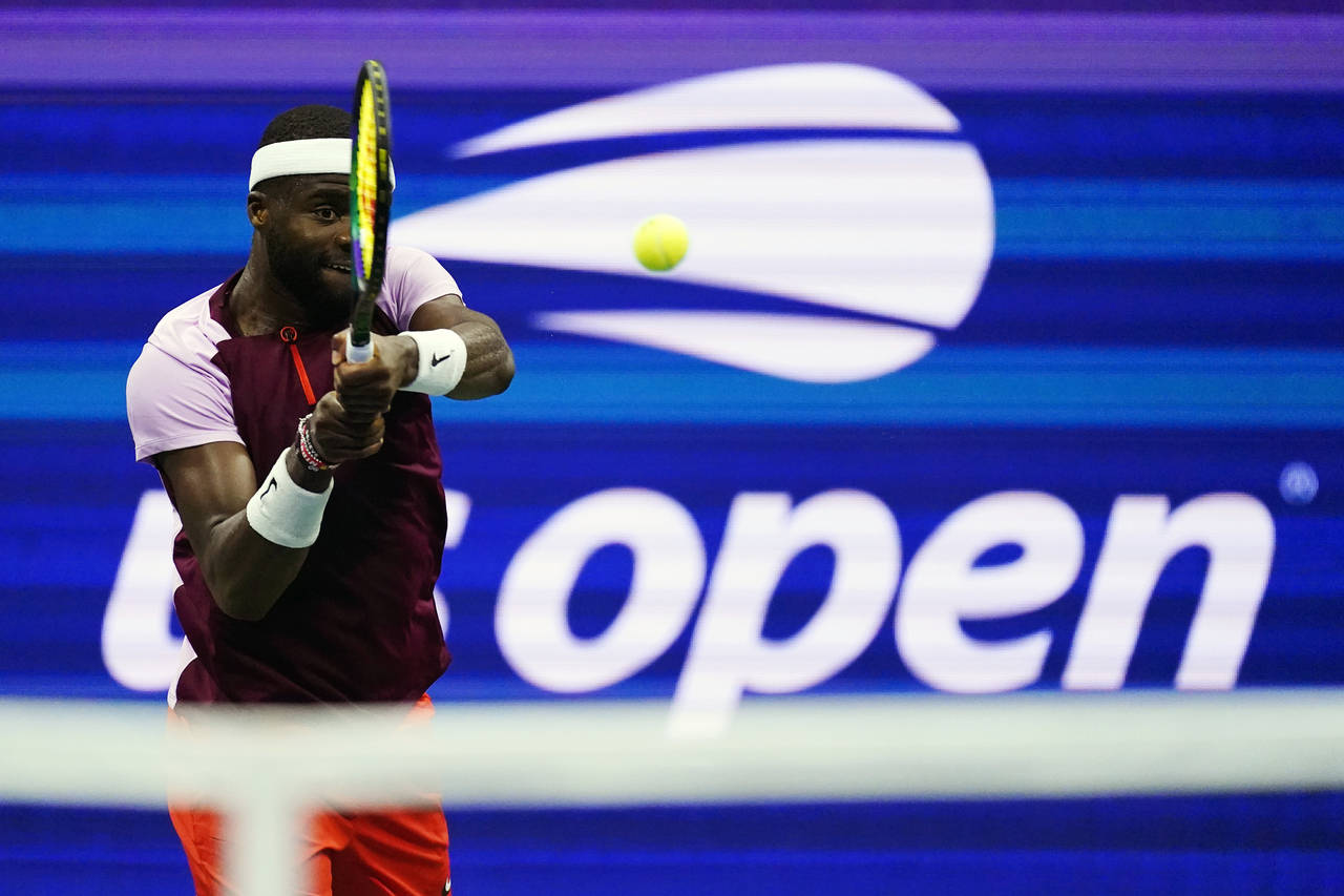 Frances Tiafoe, of the United States, returns a shot to Carlos Alcaraz, of Spain, during the semifi...