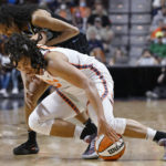 
              Connecticut Sun center Brionna Jones, foreground and Chicago Sky guard Rebekah Gardner vie for the ball during the second half of Game 4 of a WNBA basketball playoff semifinal Tuesday, Sept. 6, 2022, in Uncasville, Conn. (AP Photo/Jessica Hill)
            