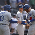 
              Los Angeles Dodgers' Justin Turner, right, is congratulated by Max Muncy after hitting a grand slam against the San Diego Padres in the seventh inning of a baseball game Sunday, Sept. 11, 2022, in San Diego. (AP Photo/Derrick Tuskan)
            