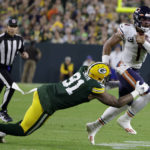 
              Chicago Bears quarterback Justin Fields (1) tries to break a tackle by Green Bay Packers linebacker Preston Smith (91) during the second half of an NFL football game Sunday, Sept. 18, 2022, in Green Bay, Wis. (AP Photo/Matt Ludtke)
            